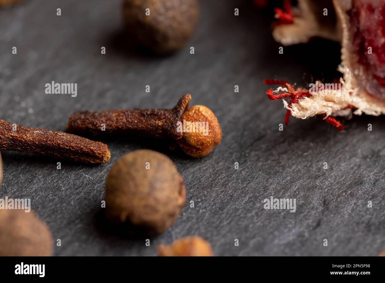 Different types of spices and nutmeg on the board, cooking with