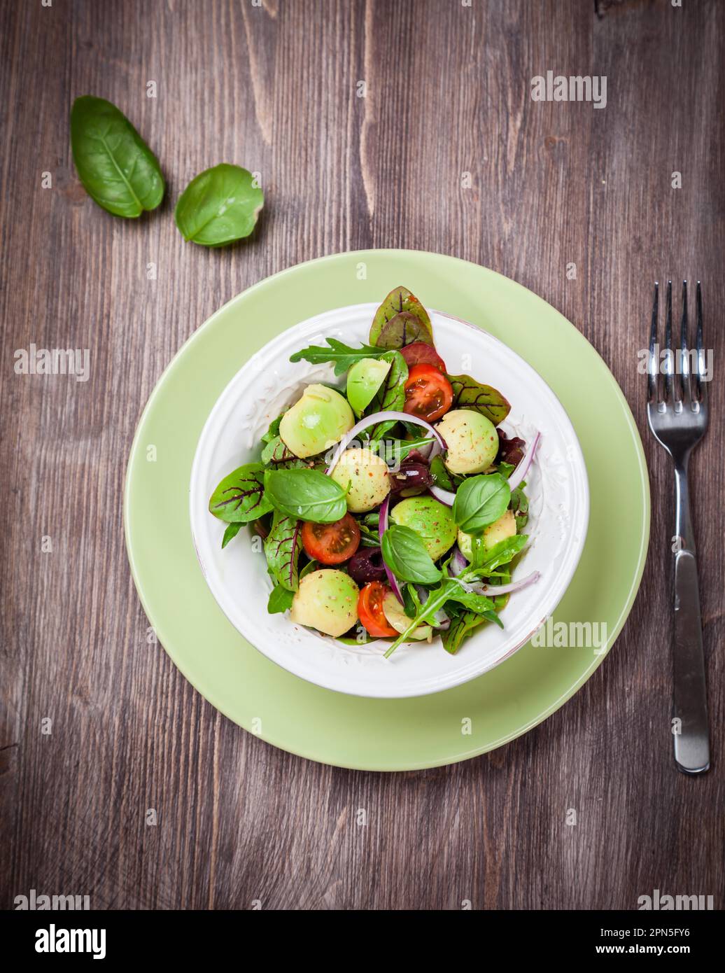 Spring mixed salad with avocado, olives and herbs Stock Photo