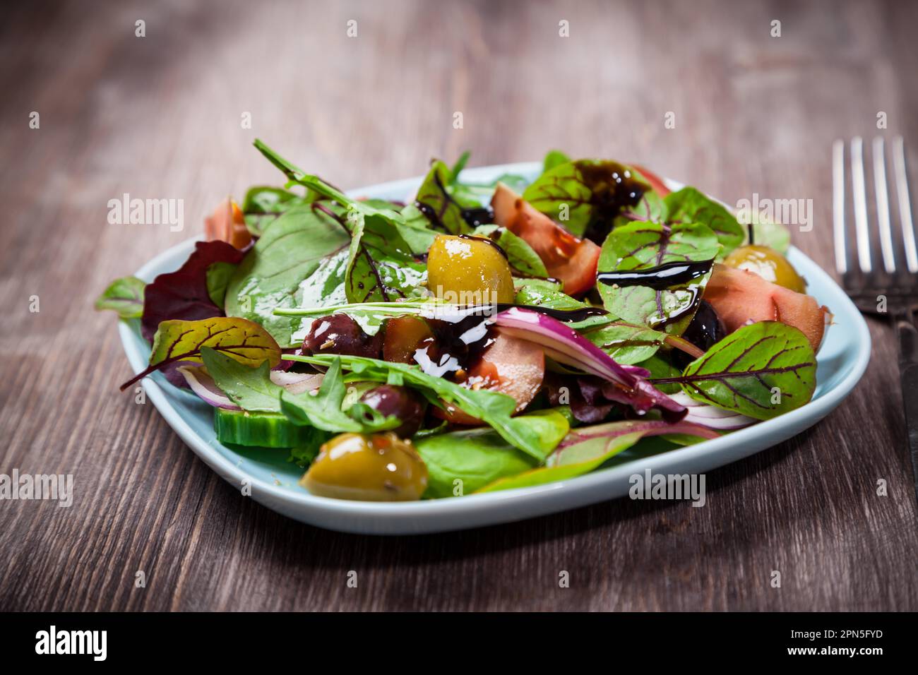 Mixed low calorie salad with olives and fresh avocado Stock Photo