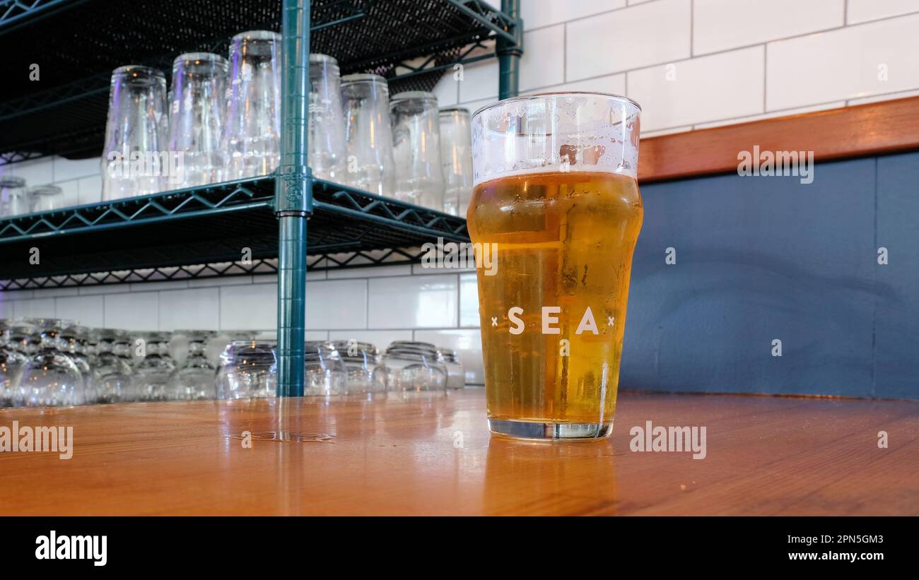 Glass of pale ale beer on the bar at Humble Sea Brewery tap room and kitchen in Pacifica, California; Santa Cruz-based craft brewery founded in 2015. Stock Photo