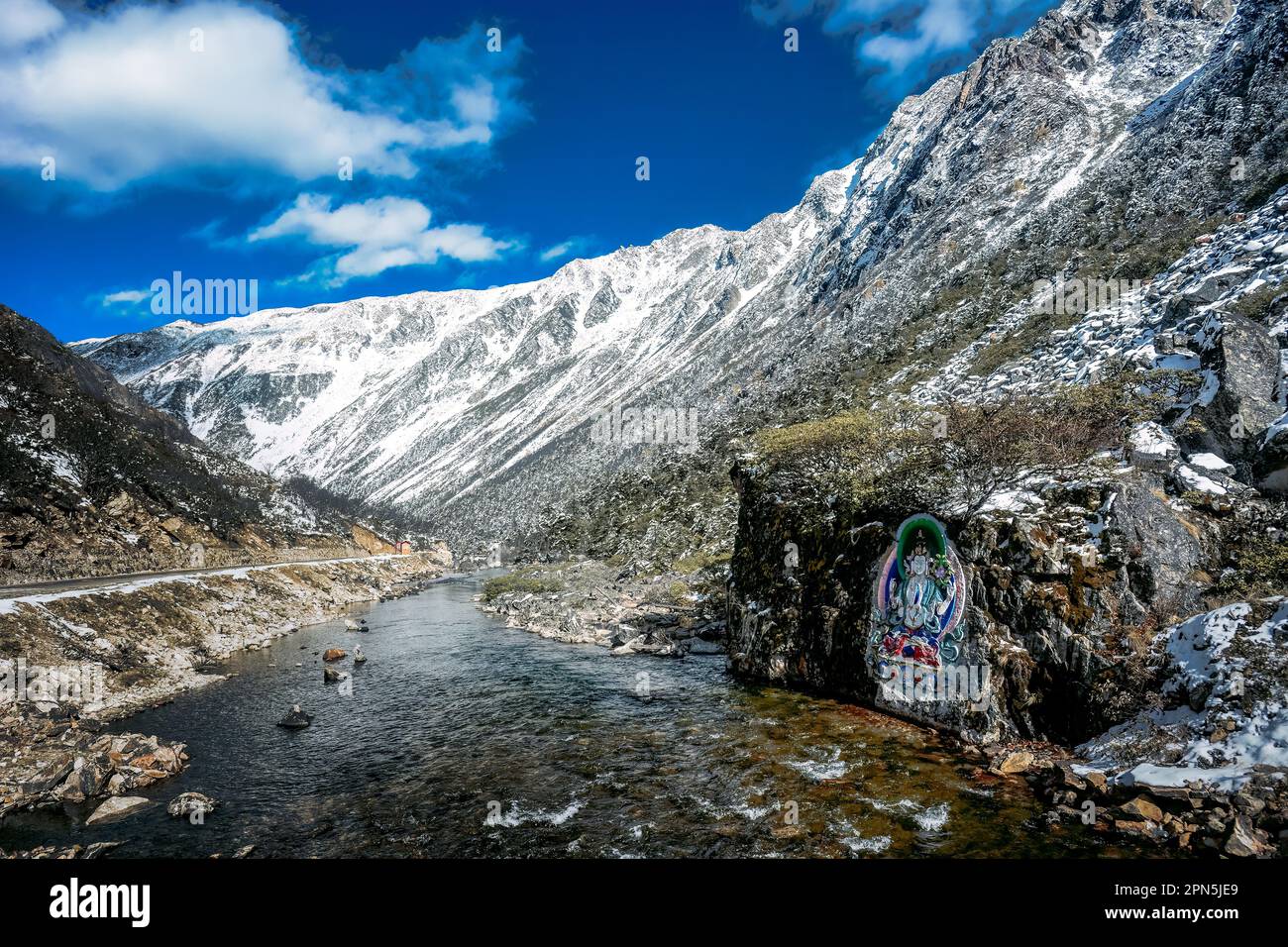 Painted stone carvings of Tibetan Buddha statues in the high mountains of Western Sichuan, China, very majestic Stock Photo