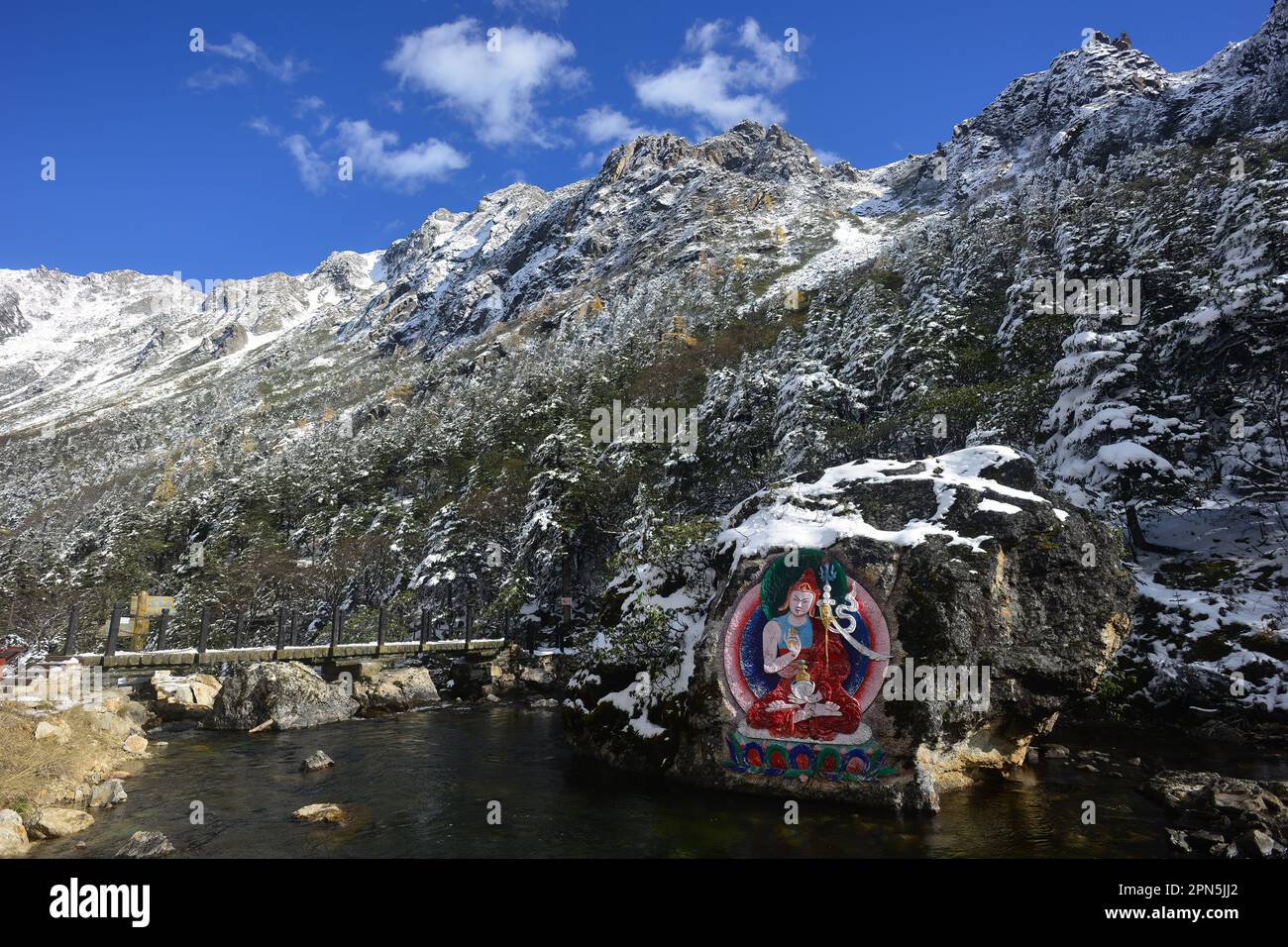 Painted stone carvings of Tibetan Buddha statues in the high mountains ...