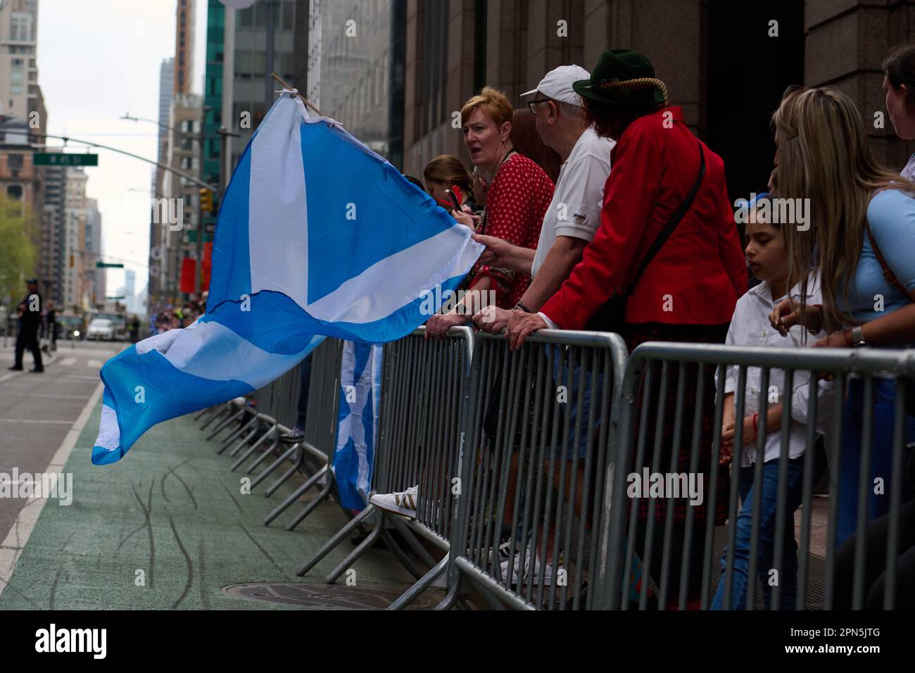 New York, New York, USA. 15th Apr, 2023. Member of the crowd standing behind barricades wave the Scottish flag at the 25th annual New York City Tartan Day Parade celebrating Scottish culture. (Credit Image: © Edna Leshowitz/ZUMA Press Wire) EDITORIAL USAGE ONLY! Not for Commercial USAGE! Credit: ZUMA Press, Inc./Alamy Live News Stock Photo