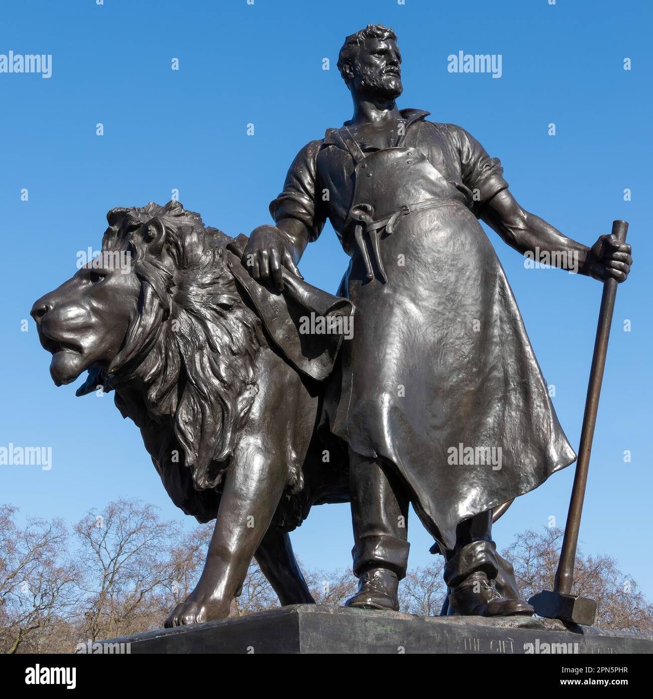 Statue of a man with lion at the Victoria Memorial outside Buckingham