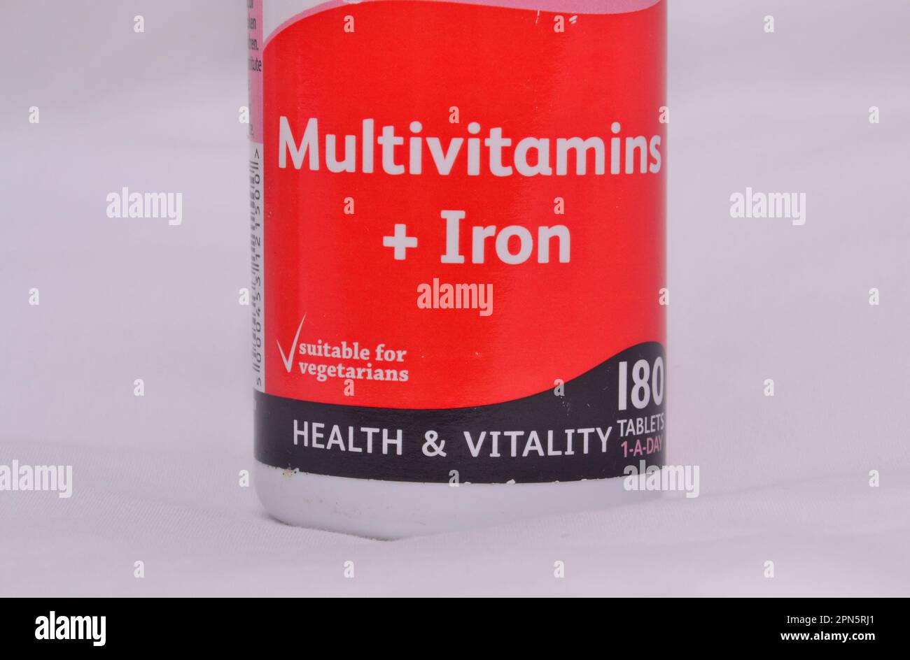 Stock image photo of a container of multivitamins and iron tablets with 'health and vitality' and 'suitable for vegetarians' text on it Stock Photo