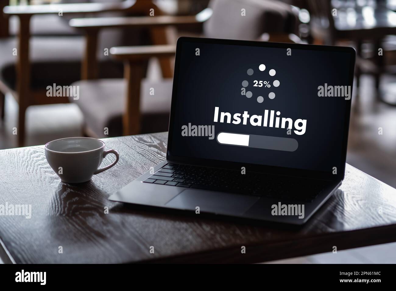man installing Software Update On Mobile Phone And Laptop digital technology communication Stock Photo