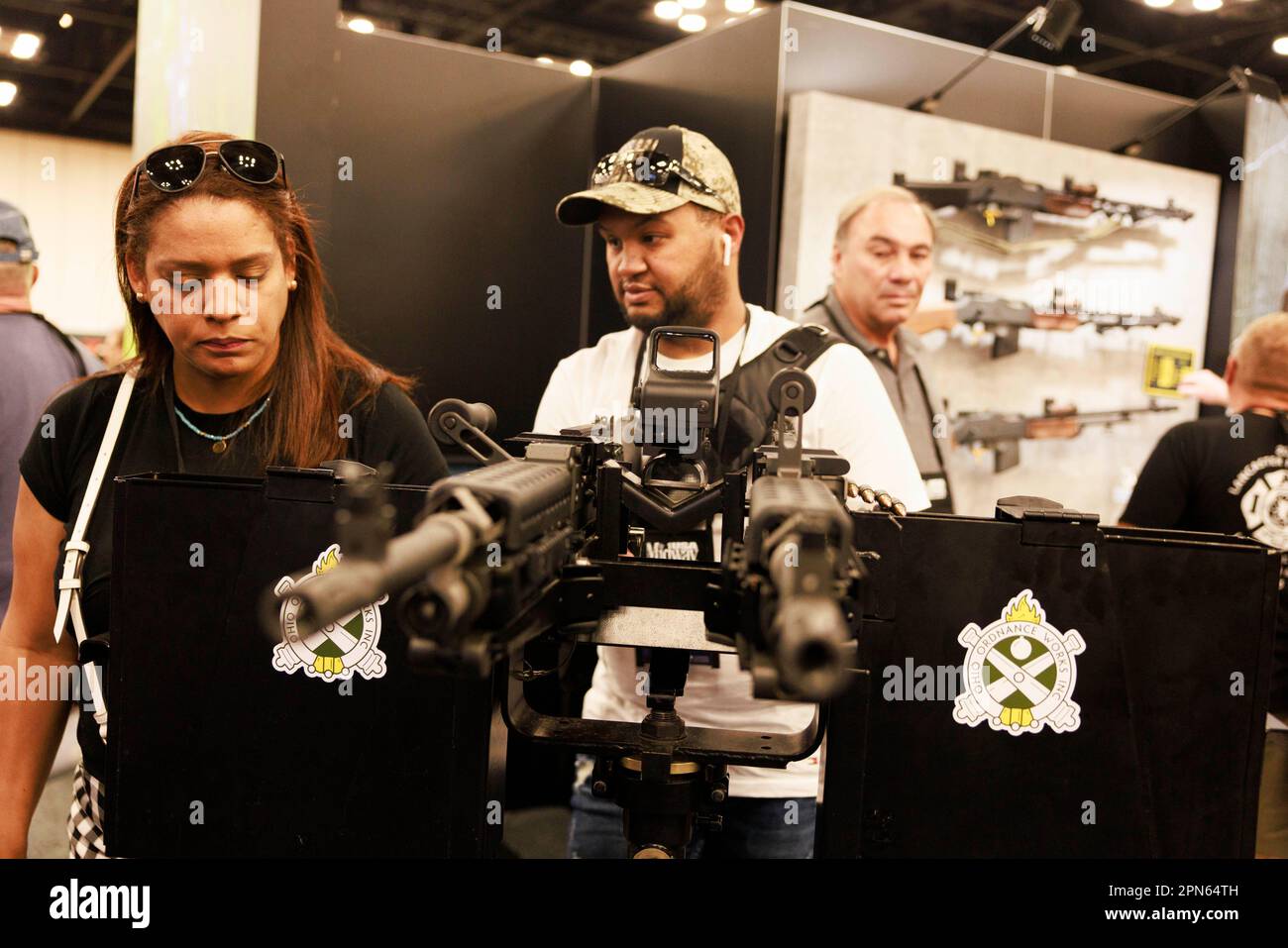 INDIANAPOLIS, INDIANA - APRIL 15: Guests look at a machine gun at the at the Ohio Ordnance Works Inc., booth during the National Rifle Association's Annual Meetings & Exhibits at the Indiana Convention Center on April 15, 2023 in Indianapolis, Indiana. The convention, which is expected to draw around 70,000 guests opened Friday. (Photo by Jeremy Hogan/The Bloomingtonian) Stock Photo