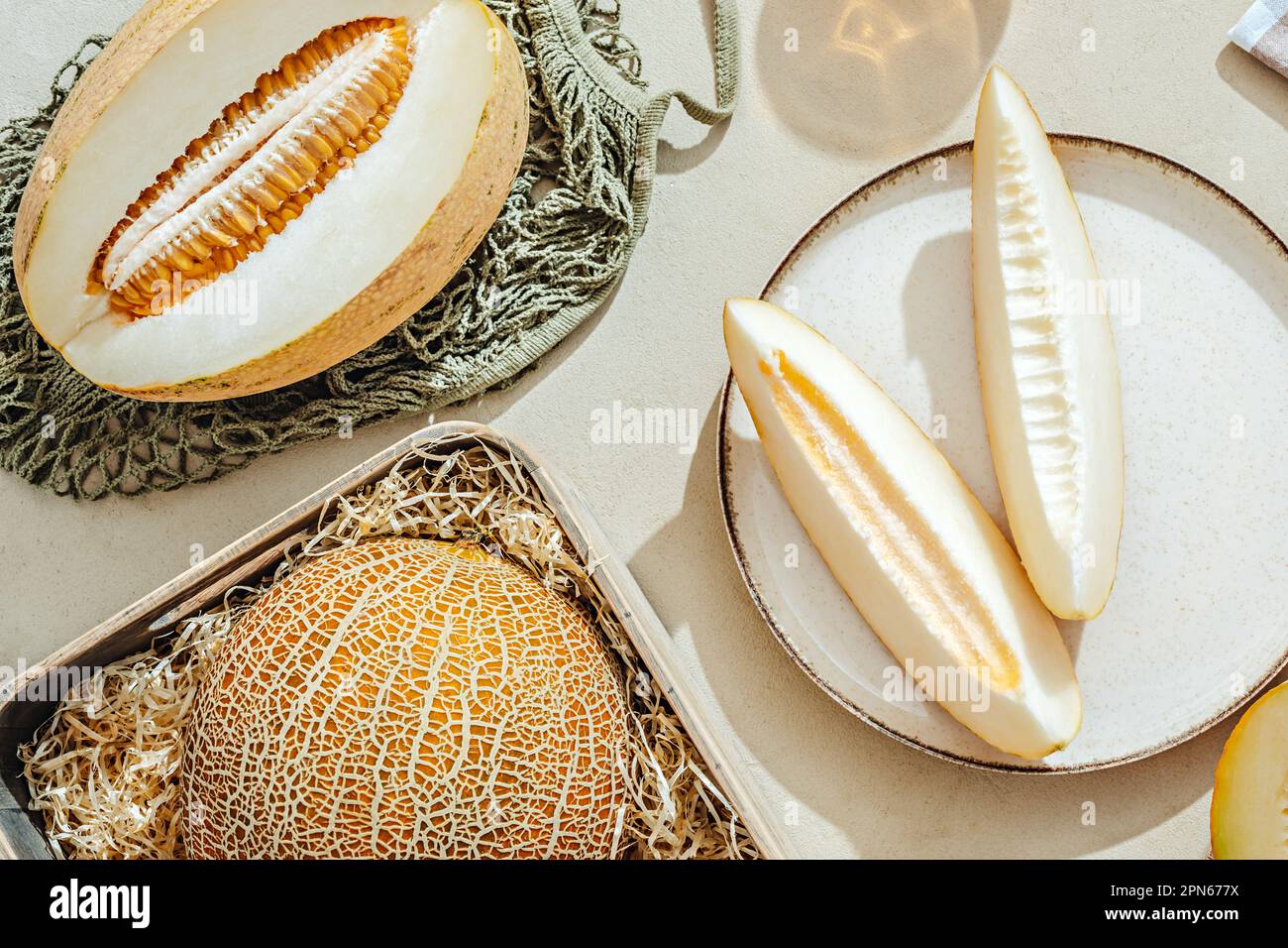 Sliced melons on a light stone background Stock Photo