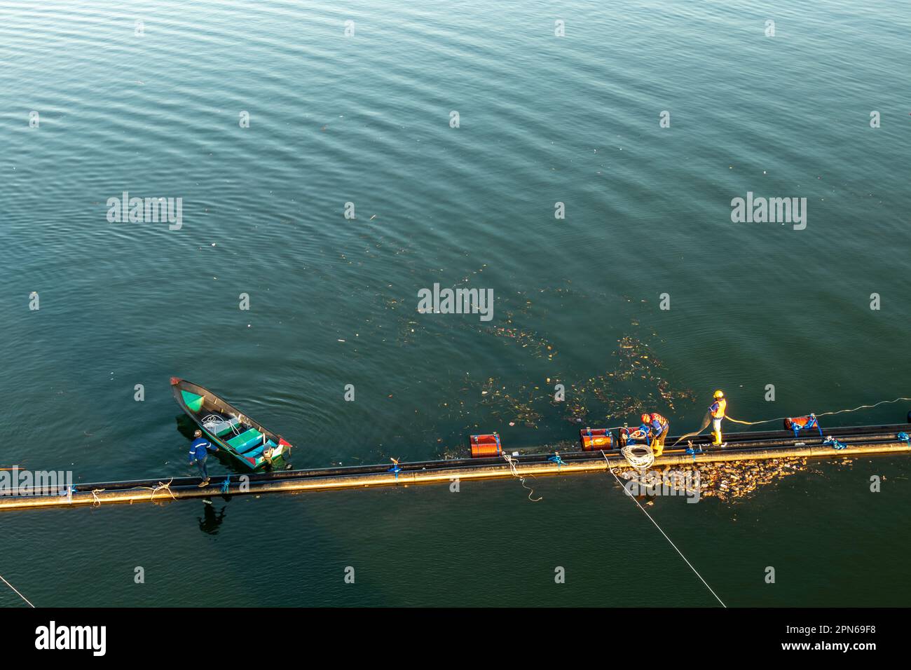 Engineering project over Mengkabong river while fishing boats continue