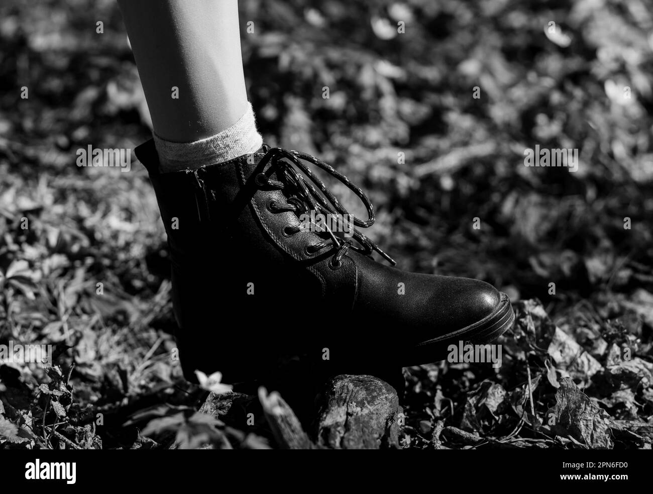 woman in black leather shoes in park. urban collection Stock Photo