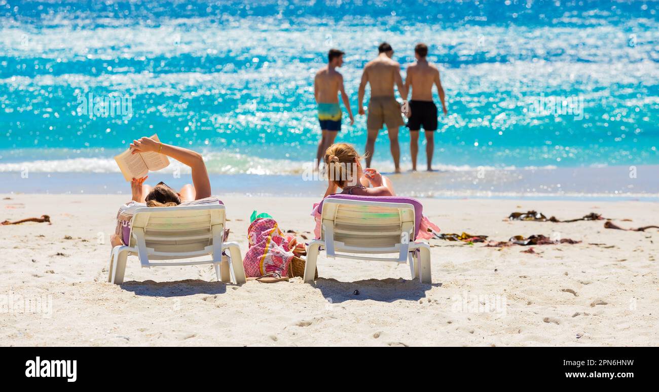 Cape Town, South Africa - February 18, 2023: View of vacationers on Camps Bay beach Stock Photo