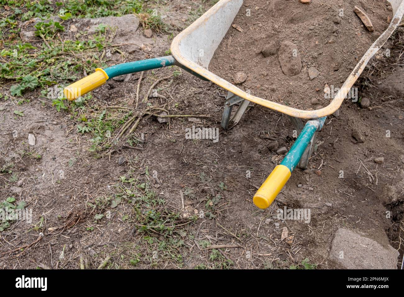 metal wheelbarrow loaded with soil Stock Photo Alamy