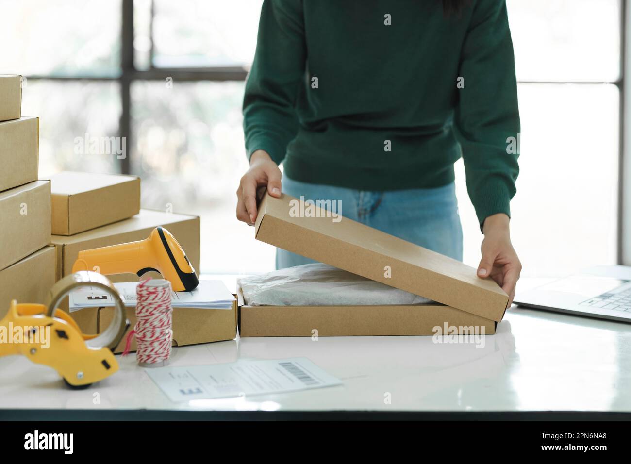 Female online business owner packing package Stock Photo Alamy