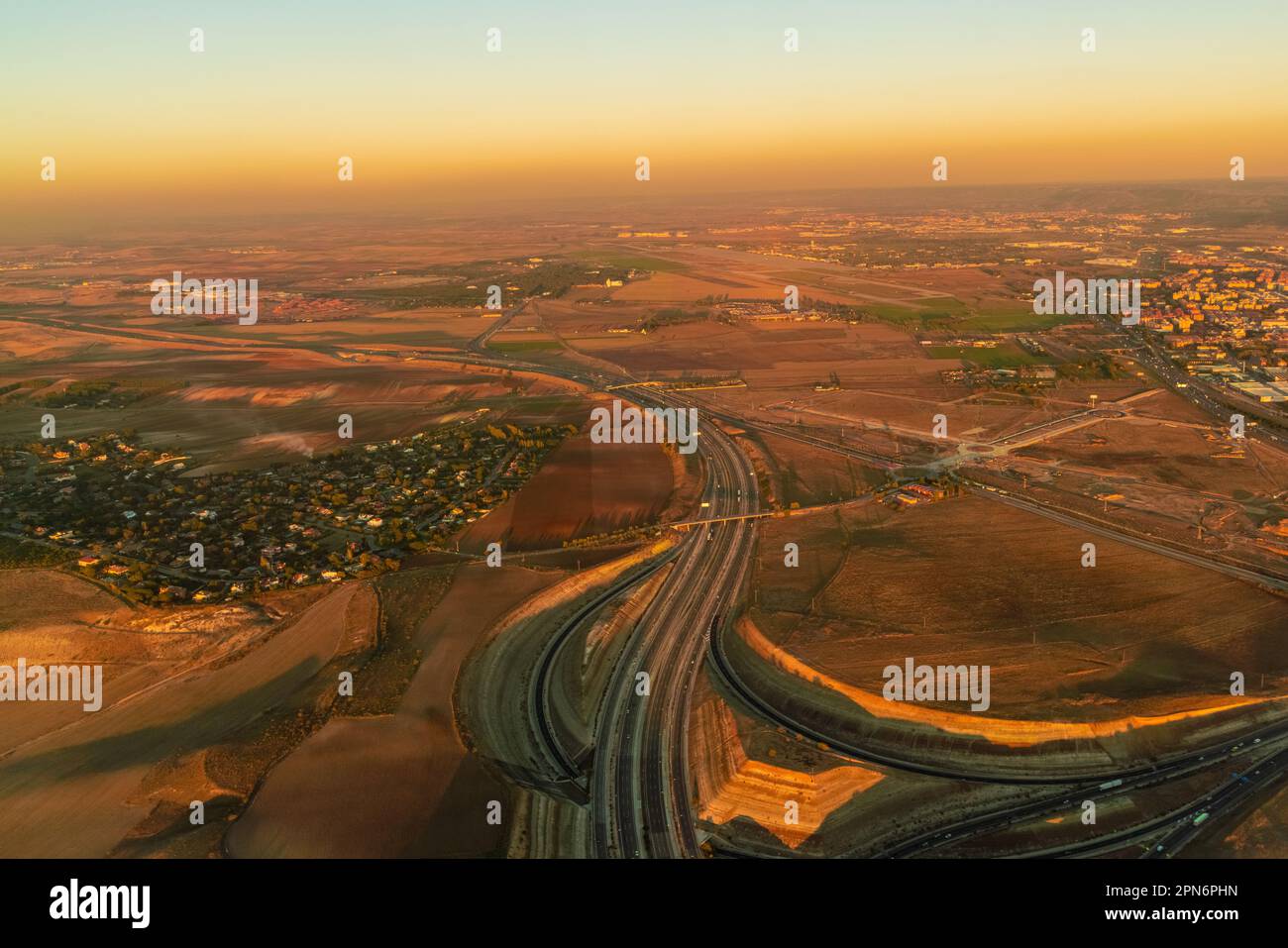 Aerial of Highway and fields close to Madrid airport, spain by sunset Stock Photo
