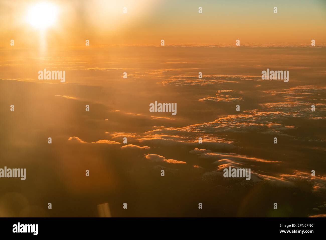 View from airplane over the clouds in Madrid, Spain by sunset Stock Photo