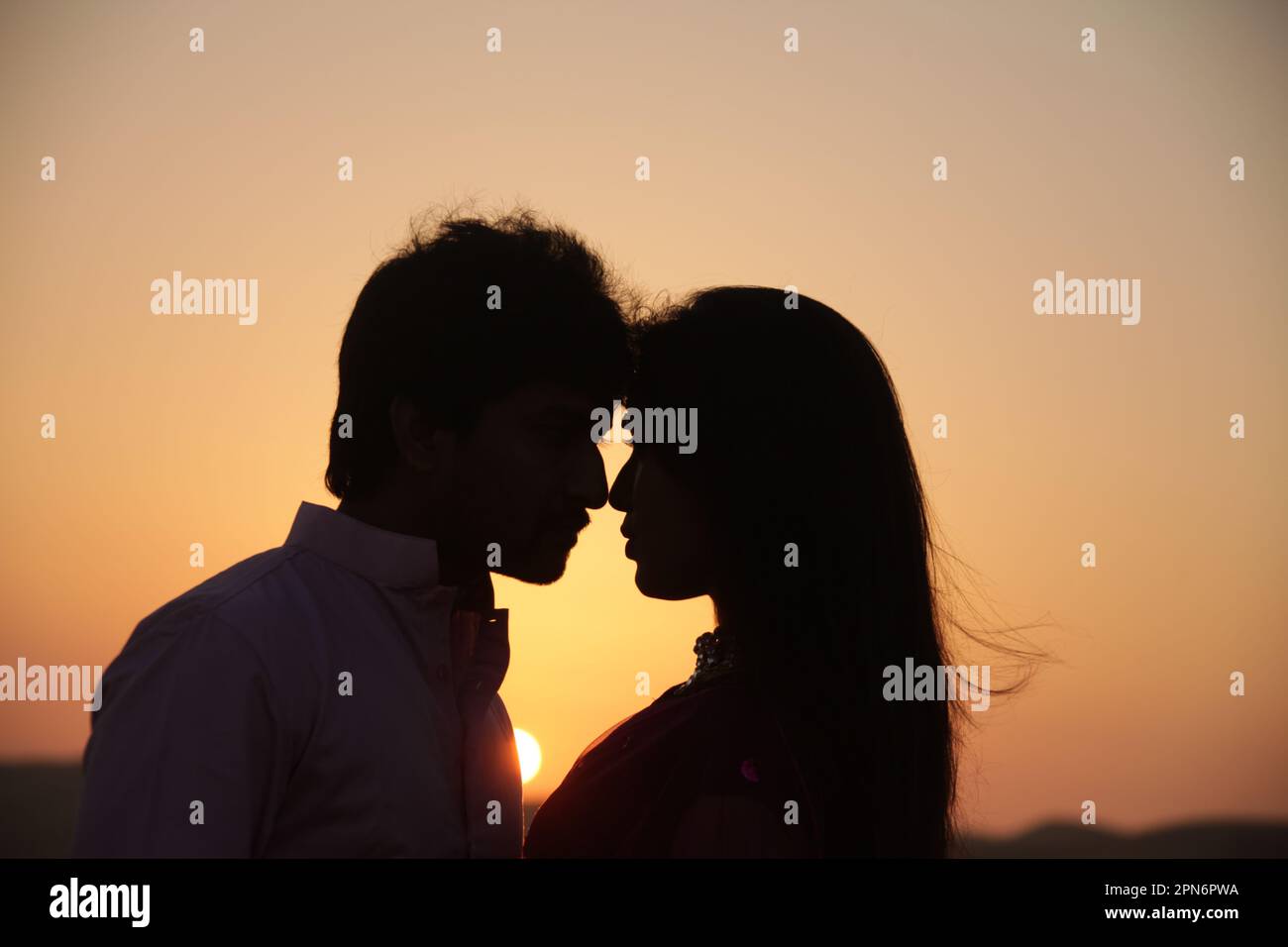 Silhouette Of Lovers at sunset Stock