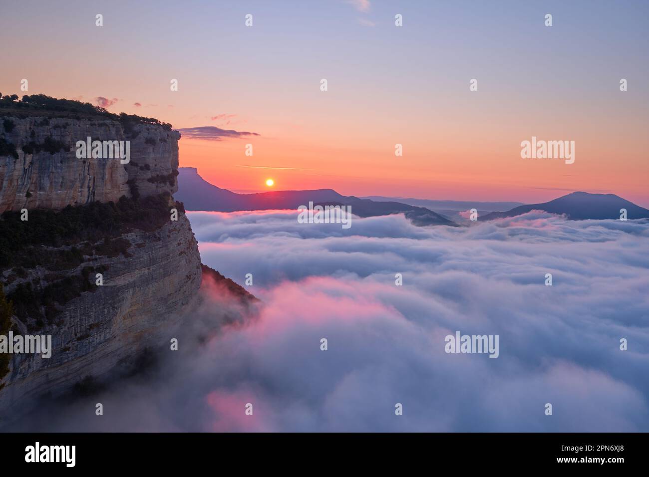 Dawn on the cliffs of Tavertet amidst a sea of fog, Tavertet, Osona, Barcelona Stock Photo