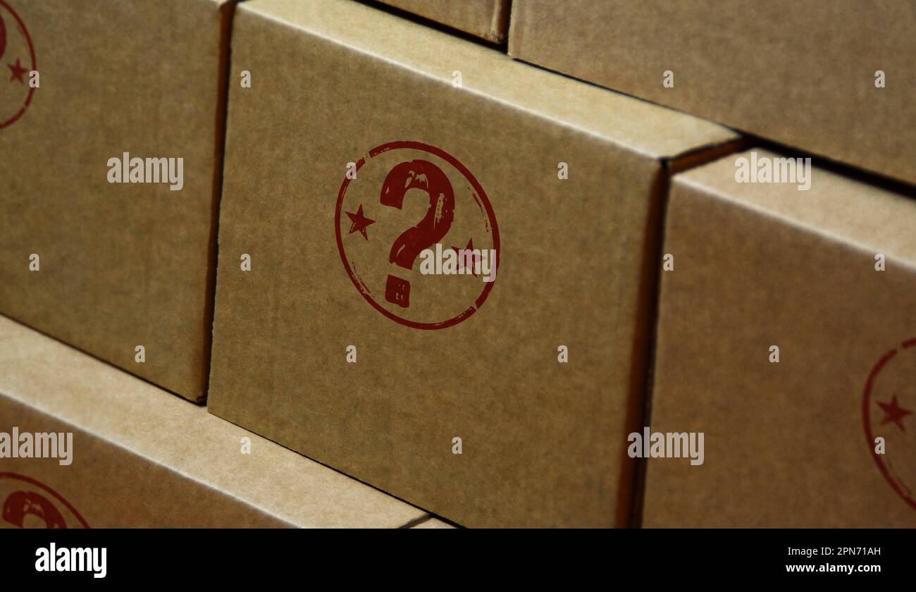 Question mark stamp printed on cardboard box. Faq help query and answer concept. Stock Photo
