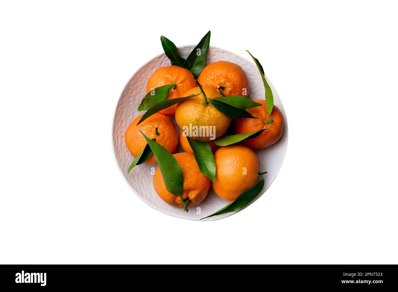 Fresh cutted clementines and whole mandarin over round plate isolated