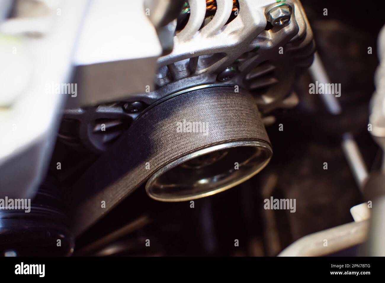 Timing belt of alternator or generator in car engine compartment