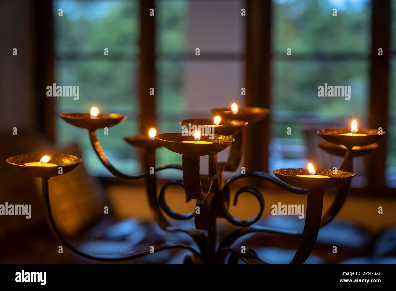 The flaming candles on a candlestick in evening. Close up Stock Photo