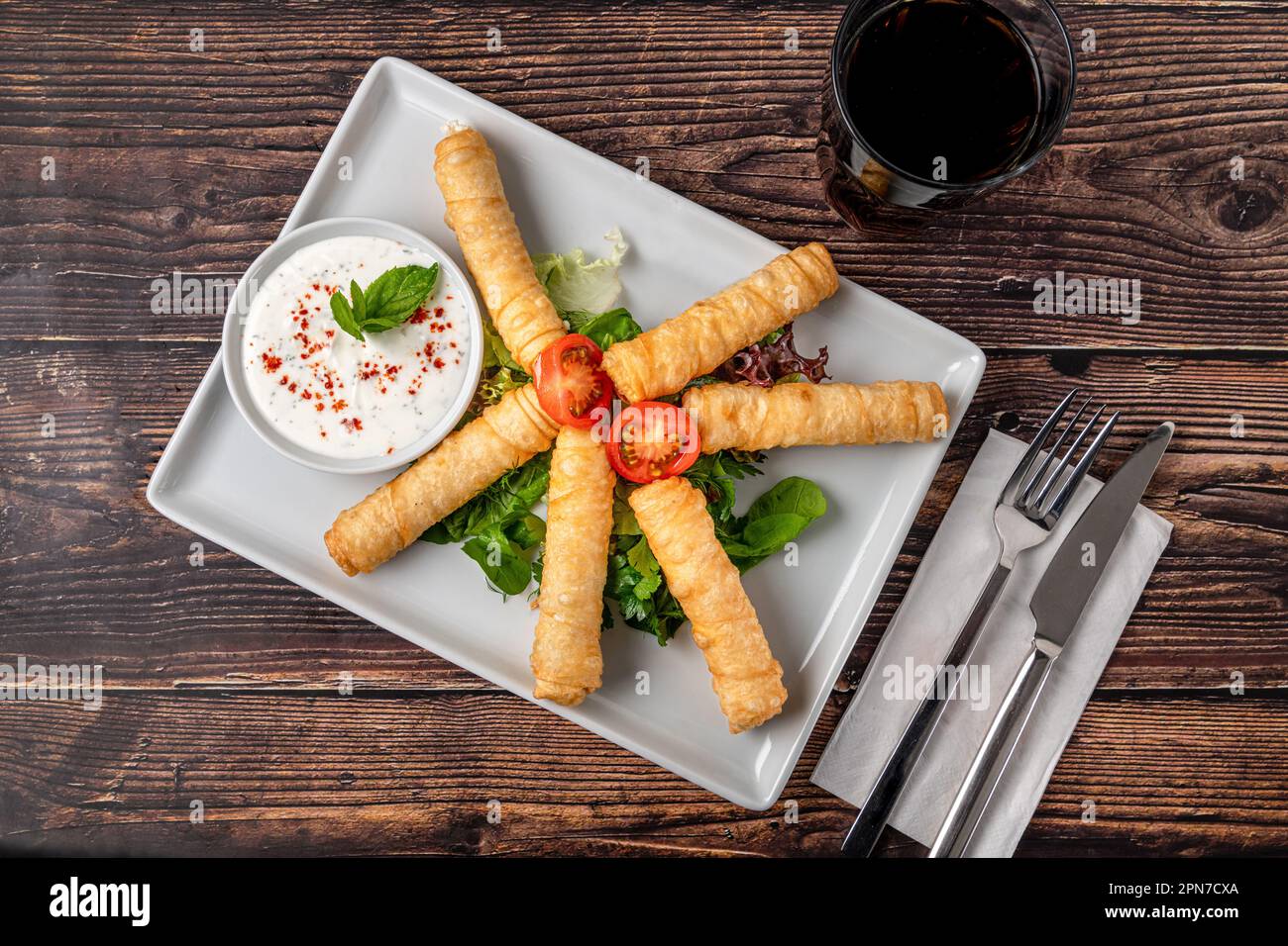 Turkish Cigar Shaped Rolls on a white porcelain plate. The Turkish name is Sigara Boregi Stock Photo