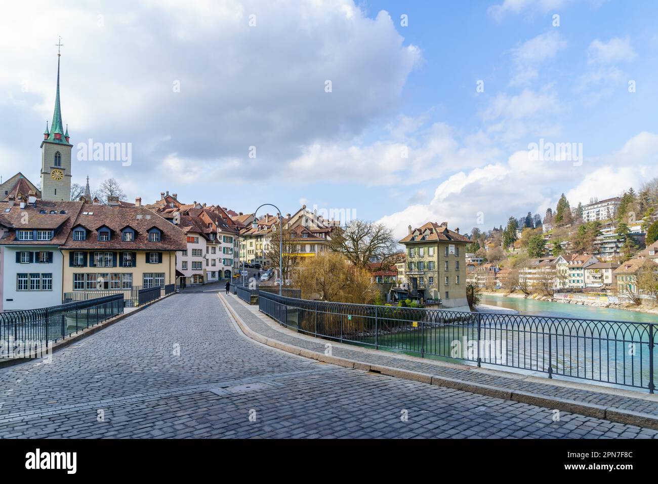 Bern, Switzerland - February 23, 2023: View of the Aare River, Untertorbrucke bridge, with Nydeggkirche church, in Bern, Switzerland Stock Photo