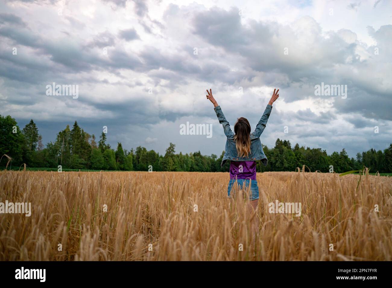 Woman arms raised rear view hi-res stock photography and images - Alamy