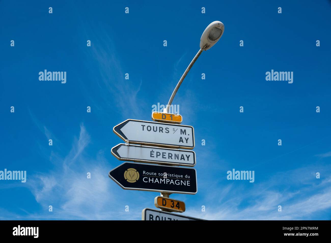 A French regional road sign for the Champagne region and the town of Epernay against a blue sky, in France, July 2019. Photographer: Bryn Colton Stock Photo