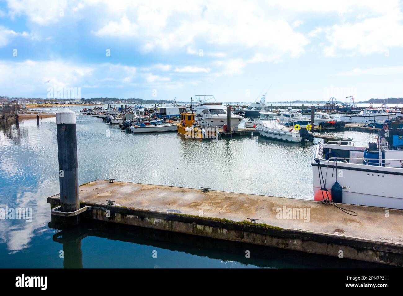 Boats moored to pontoons at Fisherman's Dock in Poole Harbour in Dorset