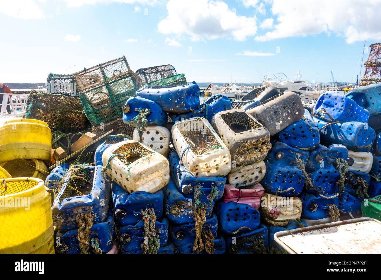Crab pots and lobster pots piled up on the quayside at Poole Harbour in Dorset, UK Stock Photo