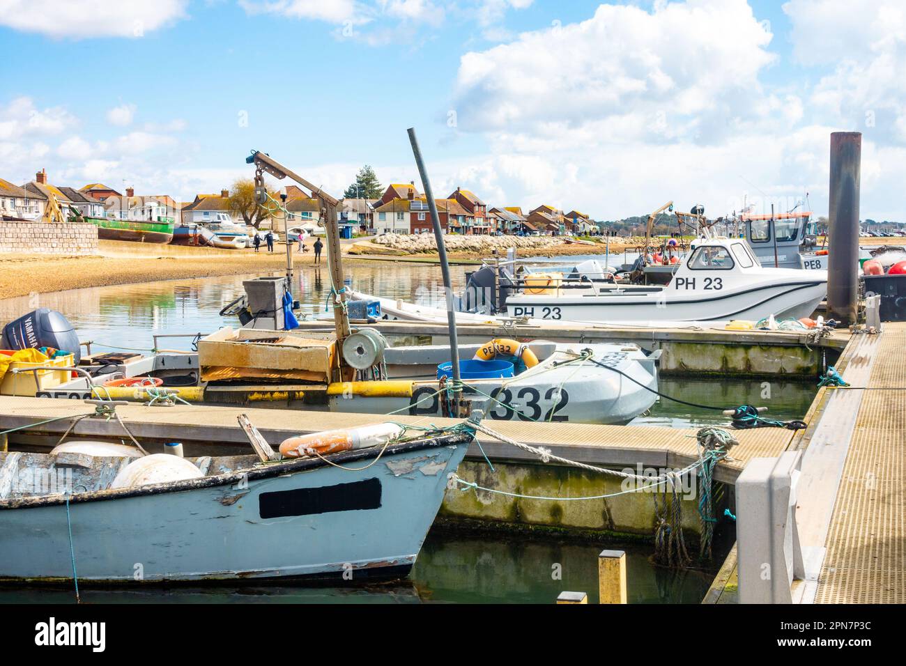 Boats moored on a pontoon in Poole Harbour in Dorset, UK Stock Photo
