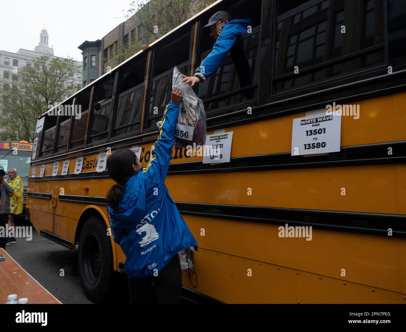 Boston, Massachusetts, USA. 17th Apr, 2023. Volunteers load runners gear on busses prior to the start of the 127th Boston Marathon. This year brings nearly 30,000 runners from more than 100 countries to run the 26.2 course from the town of Hopkinton to downtown Boston. Ten years ago a bombing at the finish line killed three and maimed scores of others. (Credit Image: © Sue Dorfman/ZUMA Press Wire) EDITORIAL USAGE ONLY! Not for Commercial USAGE! Credit: ZUMA Press, Inc./Alamy Live News Stock Photo