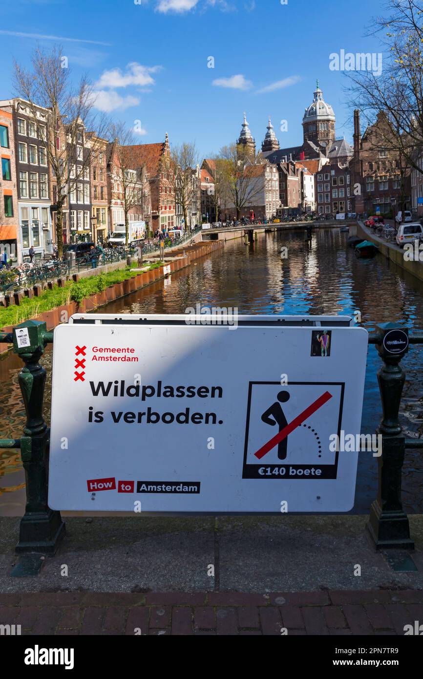No public peeing It's illegal sign in Dutch on bridge over canal at