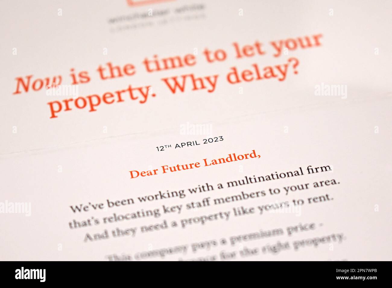 A letter is seen coming through a letter flap advertising the owner to rent out their apartment. North London. April 2023. Stock Photo