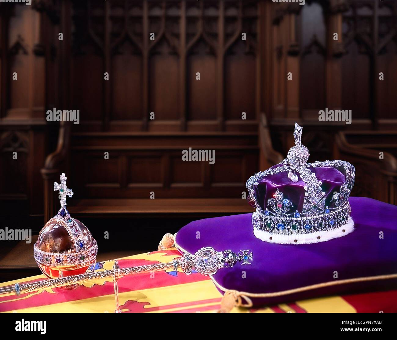 CROWN JEWELS at HM Queen Elizabeth II funeral service, inside interior at St. George’s Chapel Windsor, with the Monarch’s Imperial State Crown, Sceptre and Orb on her Majesty’s coffin, the symbols of the British Sovereign displayed during the funeral service, with conceptual harmonious background.  19/09/2022  St. Georges Chapel Windsor Berkshire UK. Unique digital image merge of UHD broadcast capture. Stock Photo