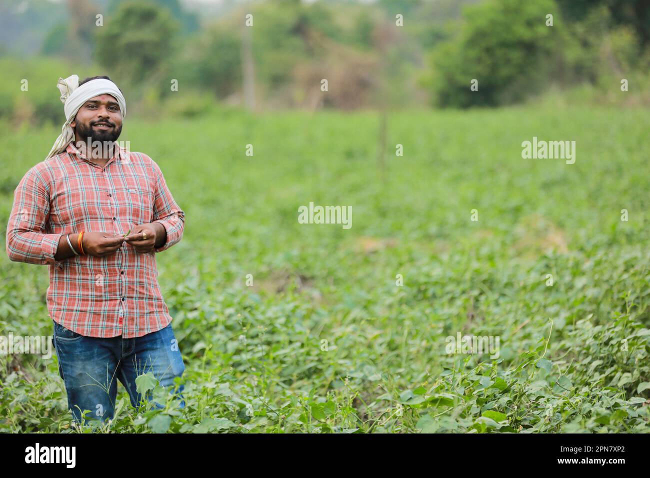 Happy Indian farmer, young farmer smiling in farm Stock Photo - Alamy