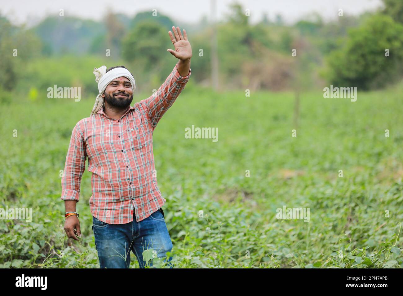 Happy Indian farmer, young farmer smiling in farm Stock Photo - Alamy