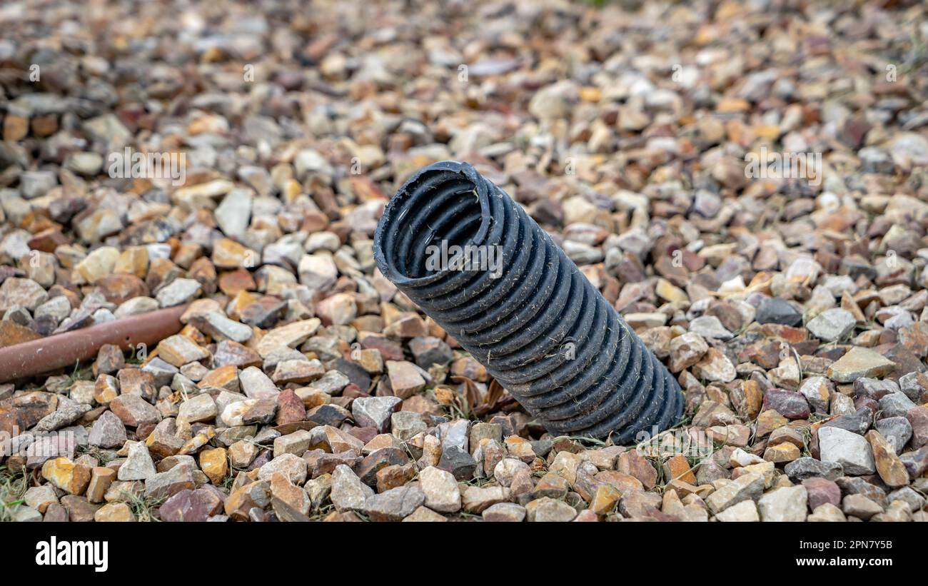 A piece of black plastic pipe sticking from the ground Stock Photo Alamy