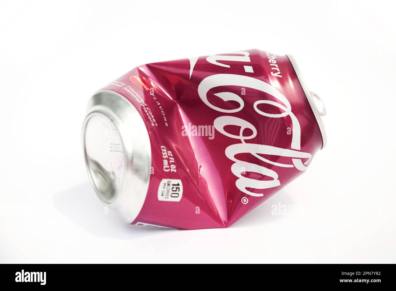 Ho Chi Minh City, Vietnam - April 16, 2023: Crushed aluminum soda can with Coca-Cola logo isolated on white. Opened empty crumpled can of famous soft Stock Photo