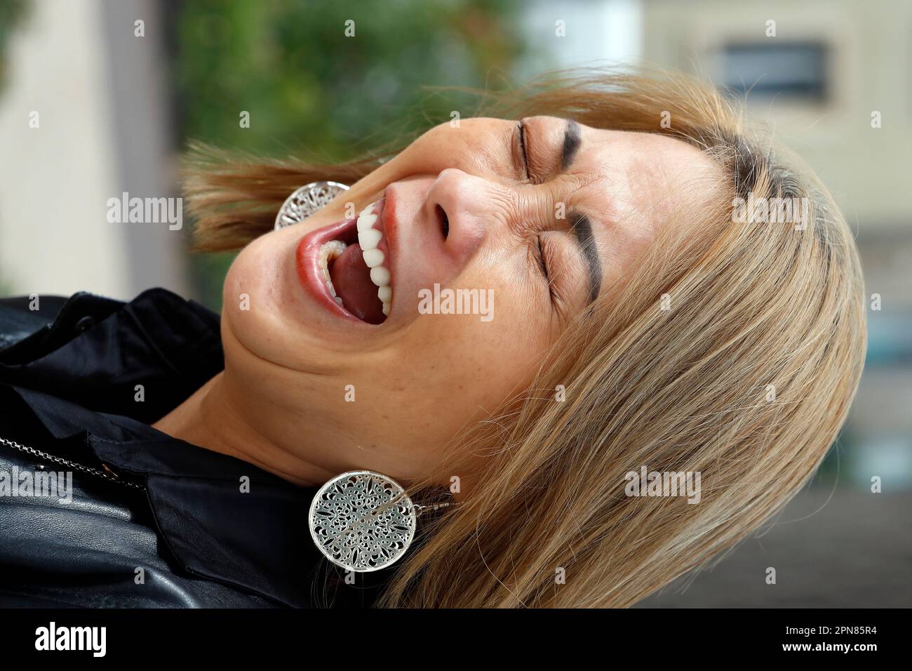 Portrait of young woman laughing. Stock Photo