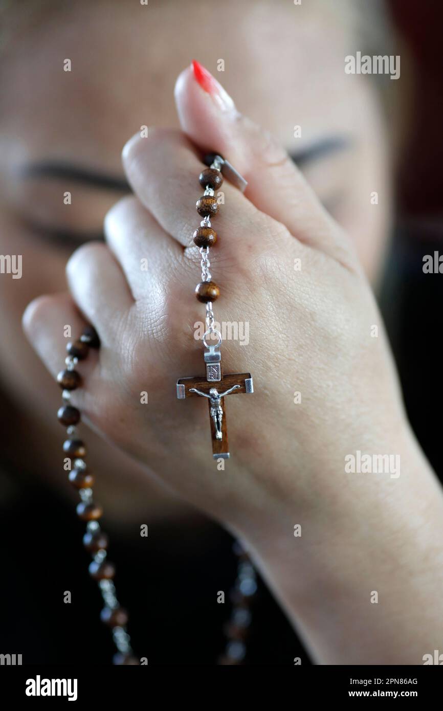 Woman praying the Rosary in a church. Mystery of the rosary Stock Photo ...