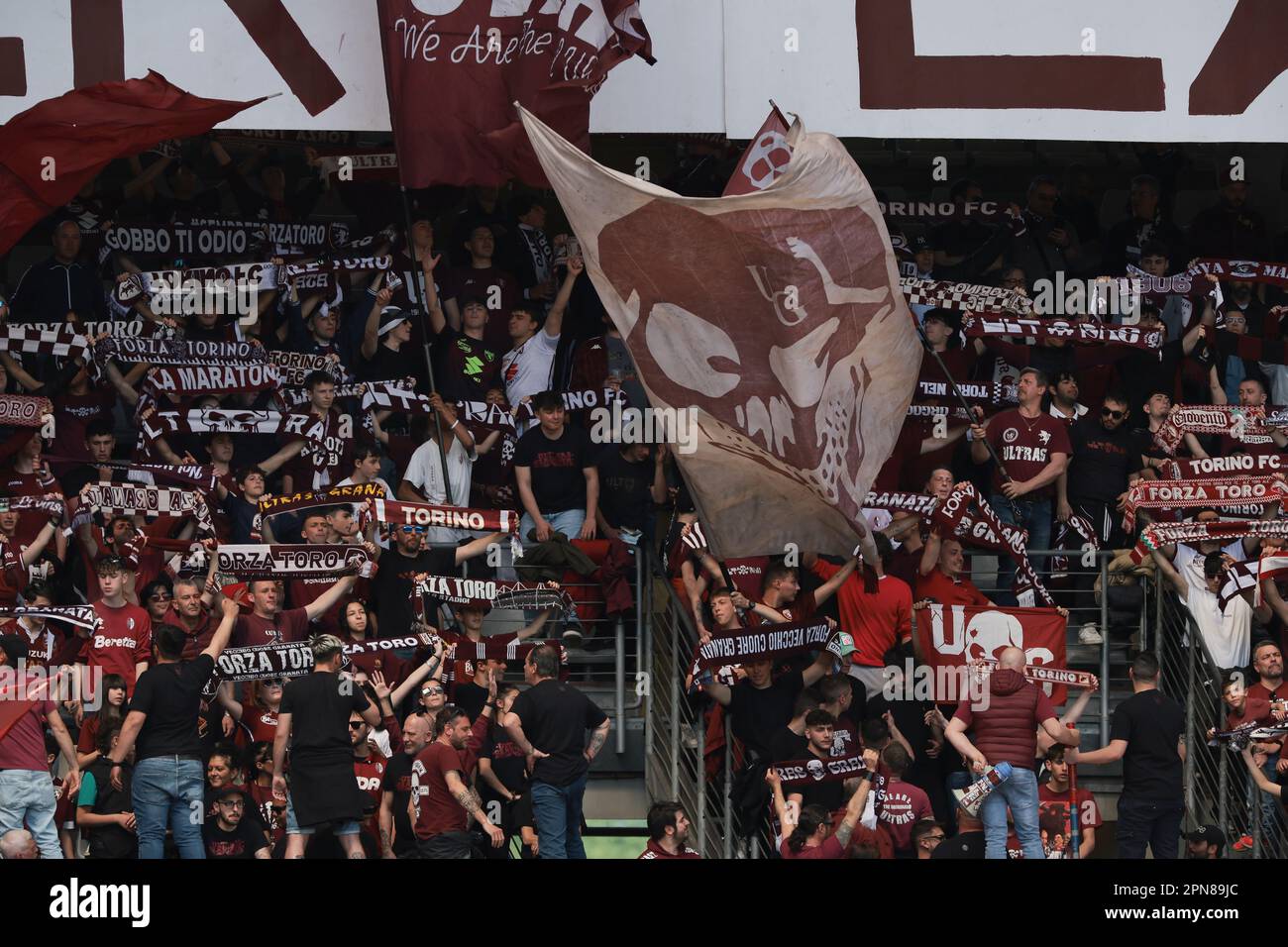 Turin, Italy, 16th April 2023. Torino FC fans hold aloft their scarves and  wave giant flags prior to the Serie A match at Stadio Grande Torino, Turin.  Picture credit should read: Jonathan