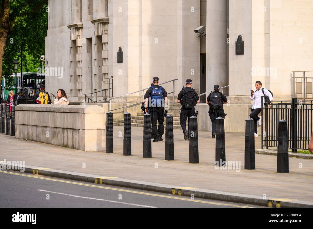 LONDON - May 18, 2022: Vigilant Armed Police with backpacks at Ministry of Defence, London. Stock Photo