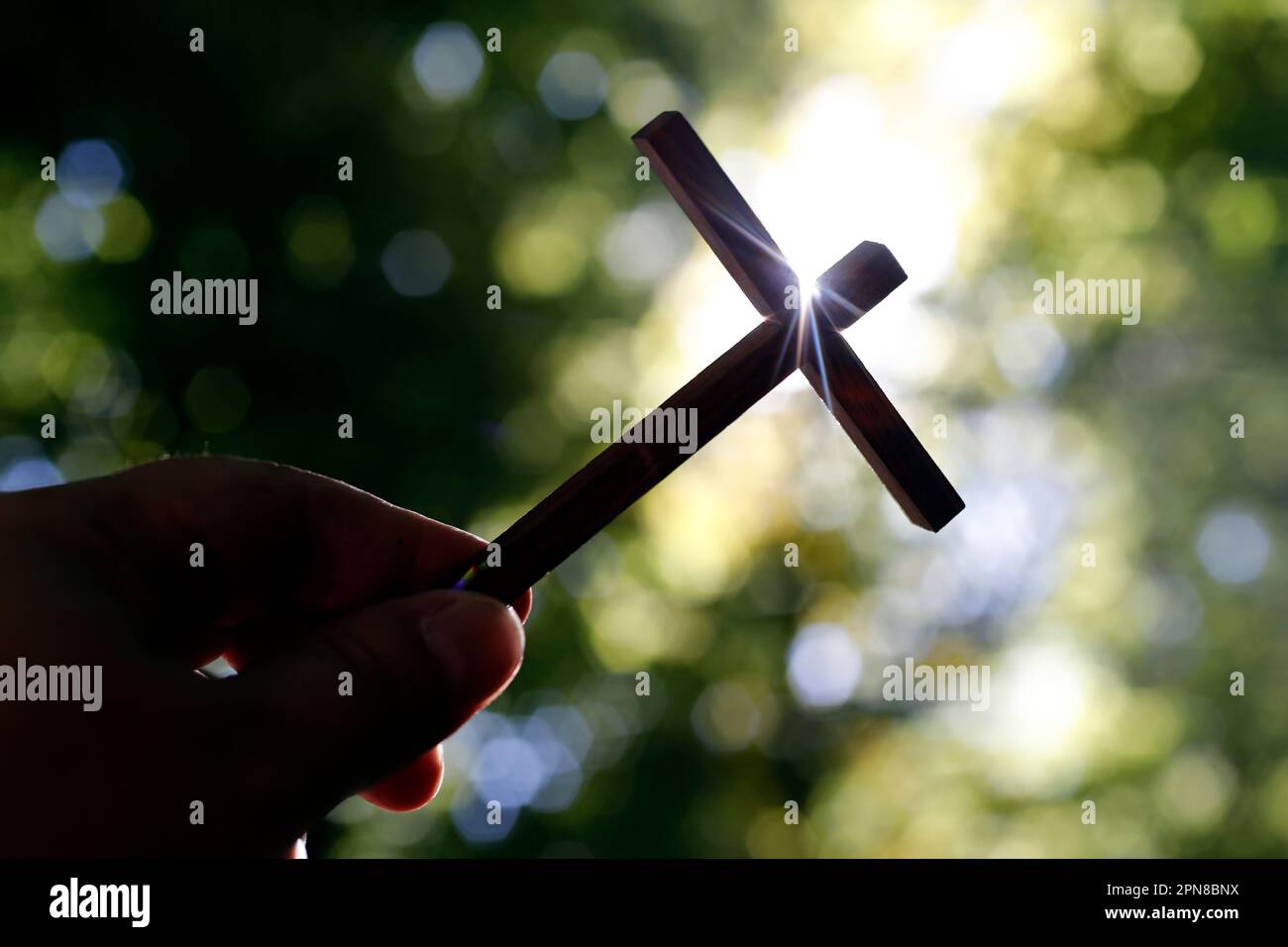 Christian wooden cross in hand. Faith and spirituality concept. France