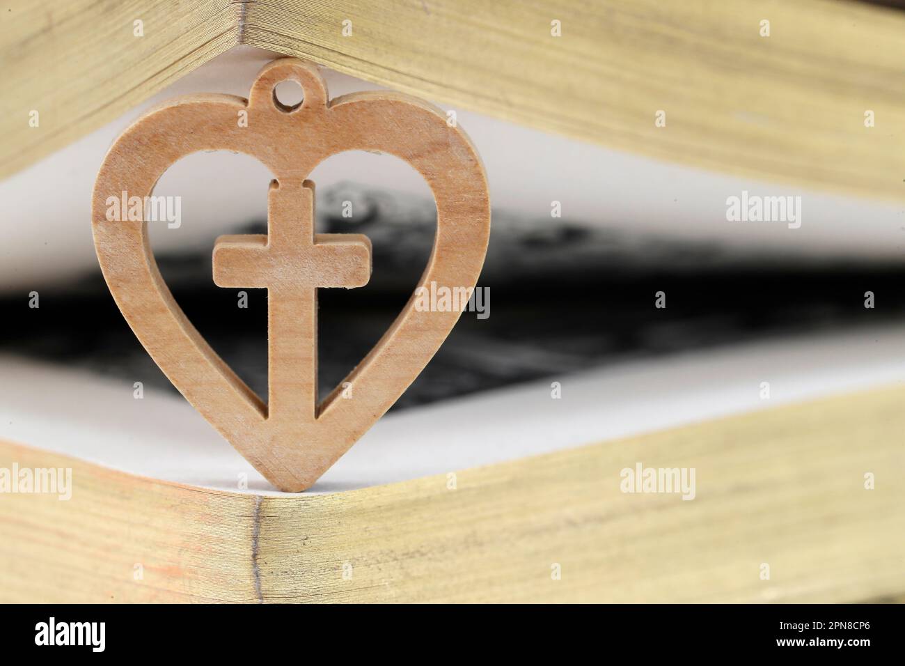 Bible with wooden heart with christian cross. Love and religion concept ...
