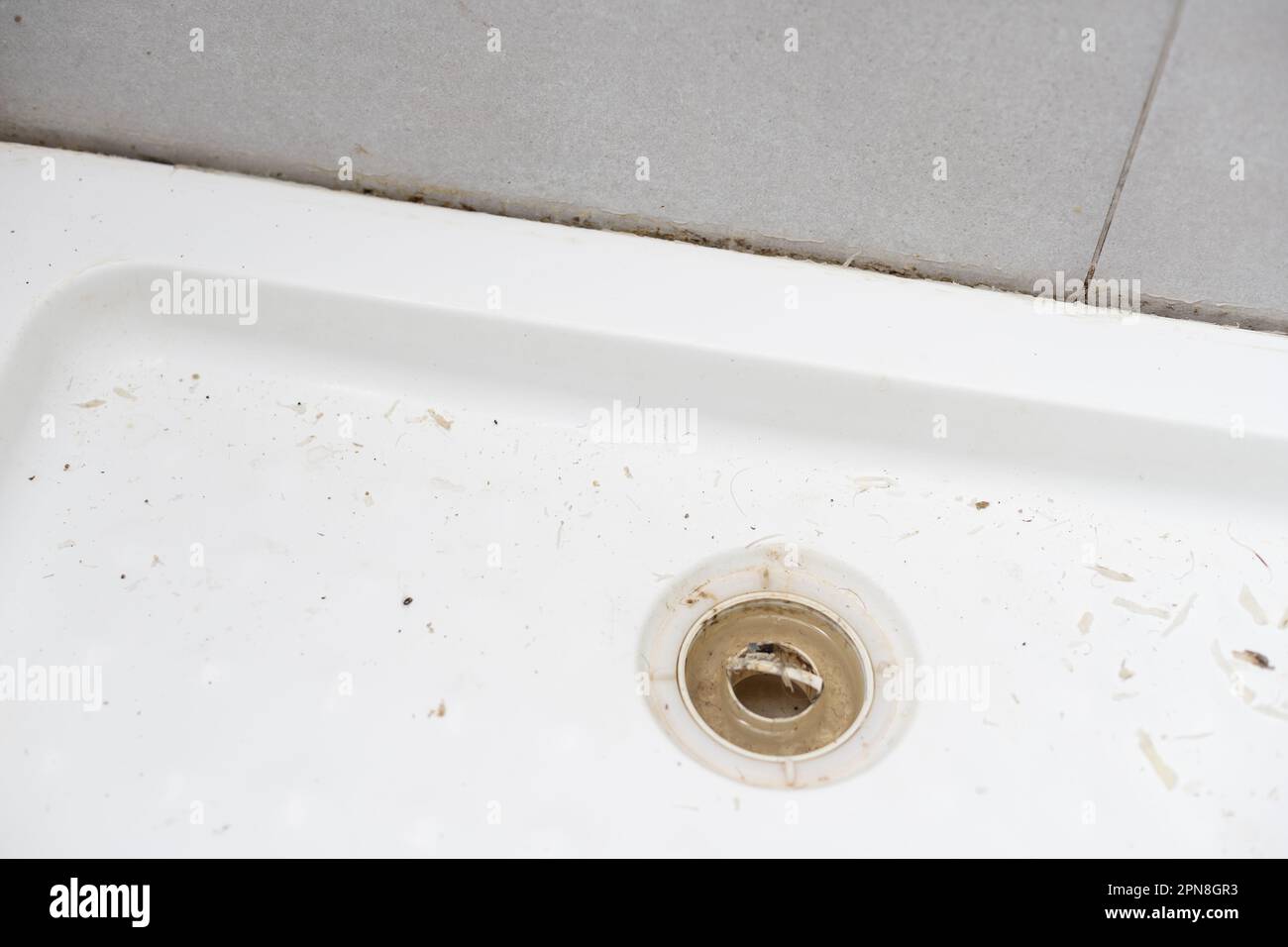 removing the old silicone from the shower cabin Stock Photo Alamy