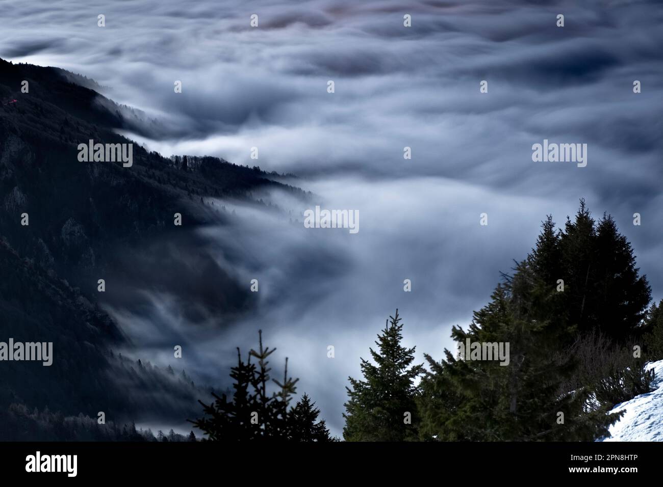 Monte Spitz Tonezza emerges from the mists on a moonlit night. Tonezza ...