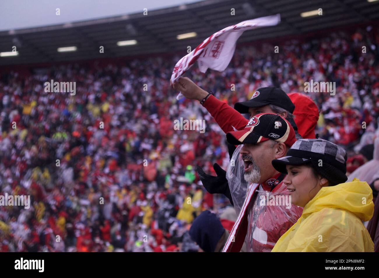 Vanessa Vega (right) and her father Robert Vega, both of Tracey and 15 year  season ticket holders cheer with other fans at Candlestick Park at the  start of the San Francisco 49ers