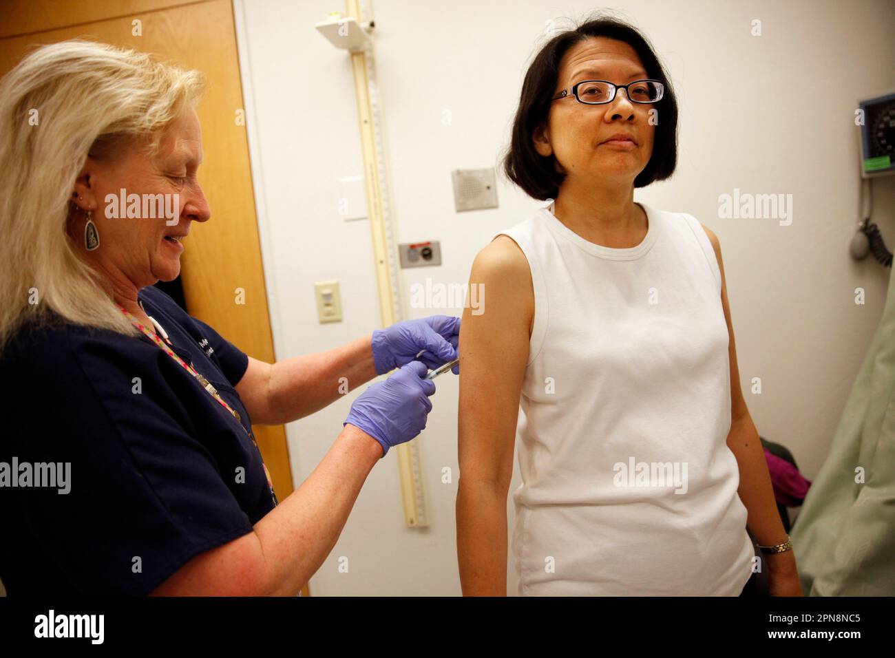 Glenna Mote (l to r), UCSF RN, gives Amy Yee of Hercules, Calif